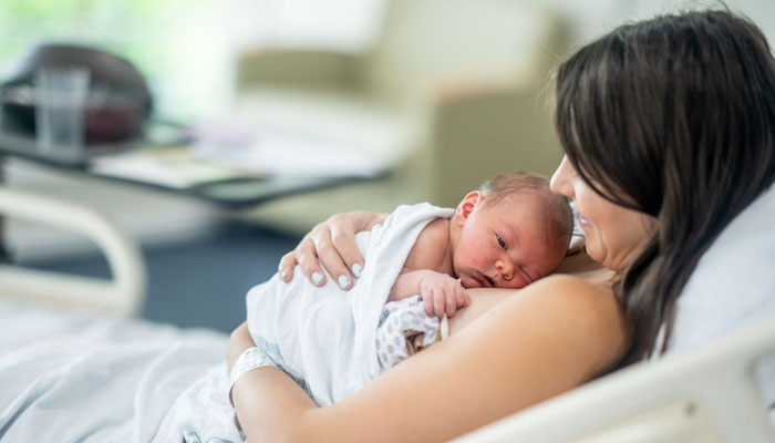 A premature baby lying in her mothers hands. — X/@chc