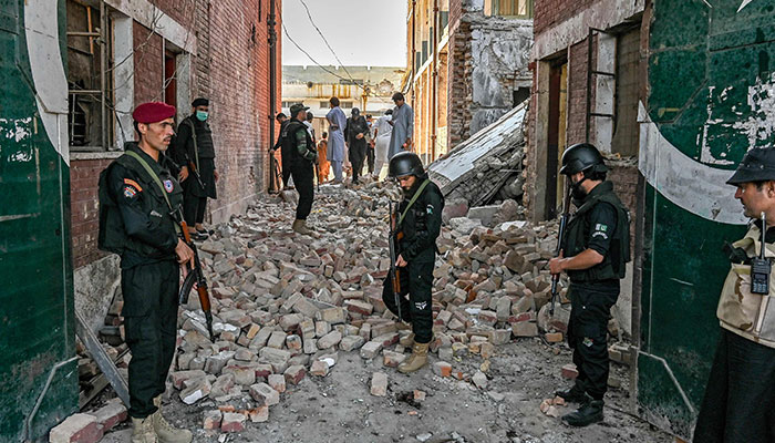 Security personnel inspect the site of a bomb blast in Bara province at Khyber Pakhtunkhwa district of Peshawar on July 20, 2023. — AFP