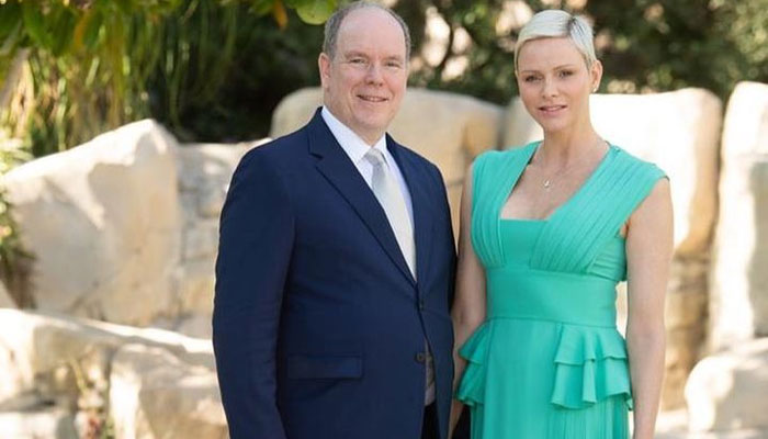 Princess Charlene flaunts her wedding ring as she poses with Prince Albert