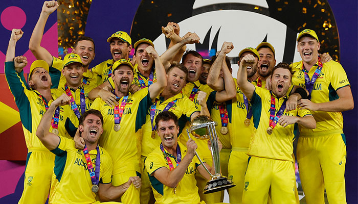 Australias Pat Cummins celebrates with the trophy and teammates after winning the ICC Cricket World Cup on November 19, 2023. — Reuters