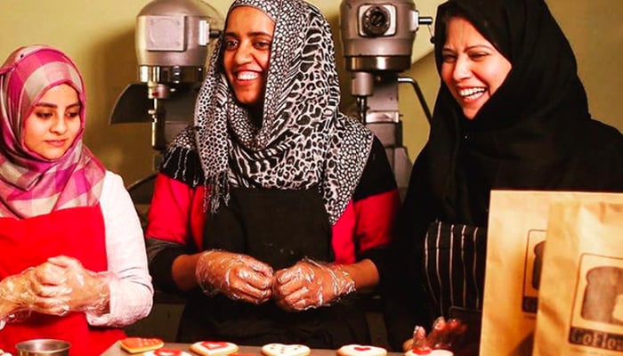 Workers at Lahores Go Flour bakery work together. — Go Flour