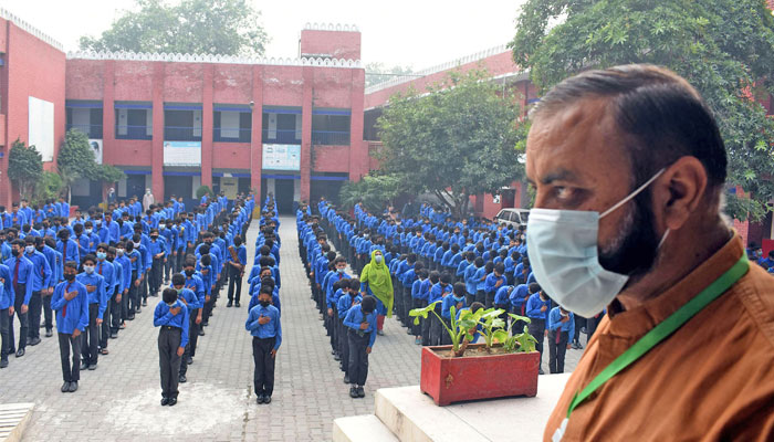 Students wearing facemasks attends the morning assembly at a school in Lahore, following Punjab governments announcement to use facemasks in schools due to severe smog. — Online/File