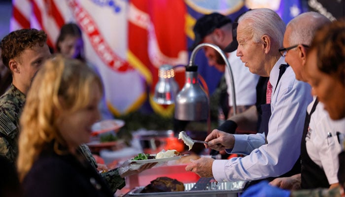 US President Joe Biden serves food to service members and their families during a Friendsgiving event ahead of the Thanksgiving holiday at Naval Station Norfolk in Norfolk, Virginia, U.S., November 19.—Reuters