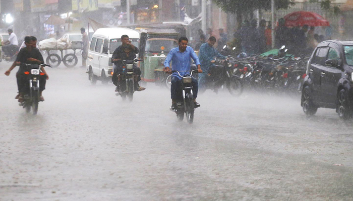 Motorcyclists commute in rain in Karachi on September 20, 2023. – INP