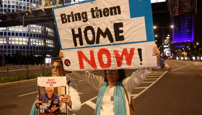 Families of Israeli hostages held by Hamas in the Gaza Strip protest outside the ministry of defence in Tel Aviv calling on November 21, 2023, amid ongoing battles between Israel and the Palestinian armed group. — AFP