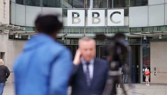 Journalists report outside BBC headquarters in London, Britain, July 12, 2023. — Reuters