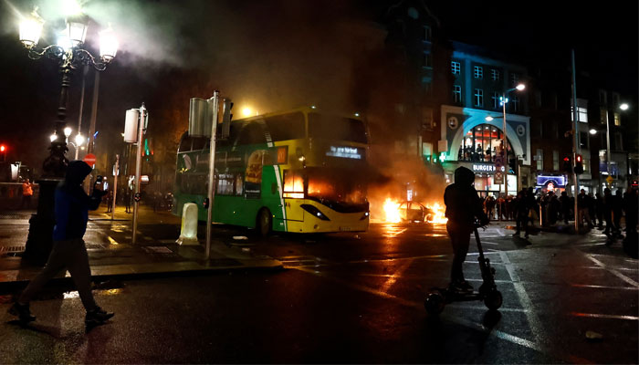 A bus burns during a demonstration following a suspected stabbing that left a few children injured in Dublin, Ireland on November 23, 2023. — Reuters