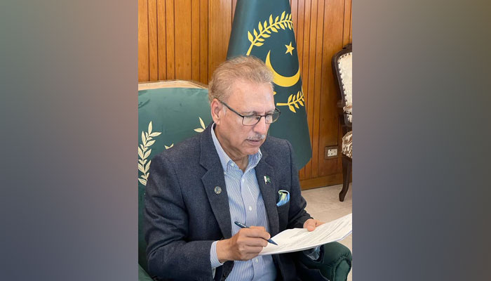 President Arif Alvi signing a document in this undated picture. — President House