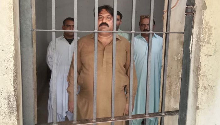 Four policemen involved in corruption are seen locked behind bars. — Sindh Police