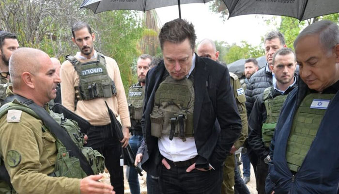 Elon Musk, center, and Benjamin Netanyahu, right, in Kfar Aza on Nov. 27. — Prime Minister of Israel