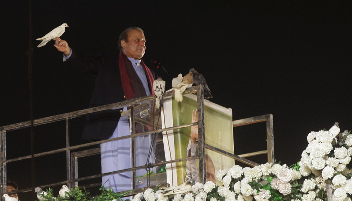 Pakistans former Prime Minister Nawaz Sharif prepares to release a pigeon in front of supporters, following his arrival from a self-imposed exile in London, ahead of the 2024 Pakistani general election, in Lahore, Pakistan, October 21, 2023. — Reuters