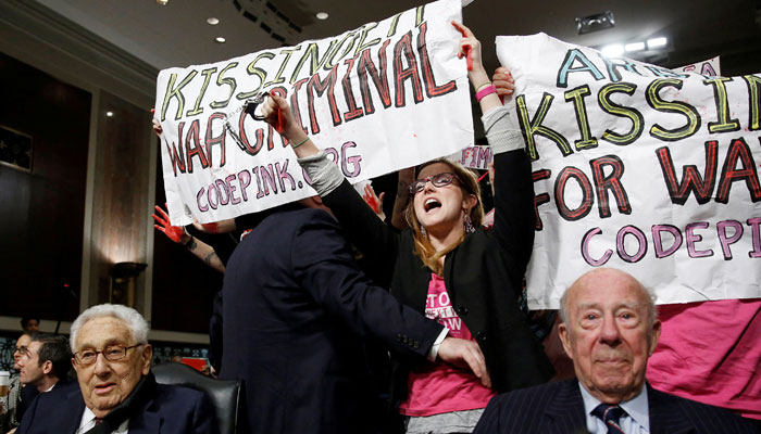 Code Pink demonstrators surround former US secretaries of state Henry Kissinger and George Shultz before the beginning of the Senate Armed Services Committee on global challenges and US national security strategy on Capitol Hill in Washington January 29, 2015. — Reuters
