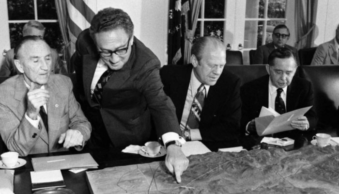 Henry Kissinger points to a map of the Sinai during a meeting with US President Gerald Ford and congressional members in the Cabinet Room at the White House in Washington DC, US, January 20, 1977. — Gerald R Ford Library/Handout via Reuters