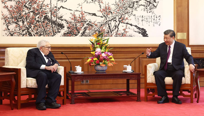 China´s President Xi Jinping (R) speaks with former US secretary of state Henry Kissinger during a meeting in Beijing on July 20, 2023. — AFP