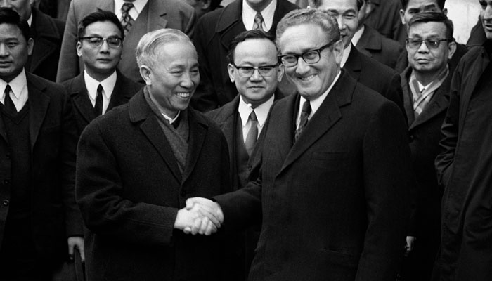 US National Security Advisor Henry Kissinger (R) shakes hands with Le Duc Tho, leader of North Vietnams delegation, after the signing of a ceasefire agreement in the Vietnam War, on January 23, 1973, in Paris. — AFP