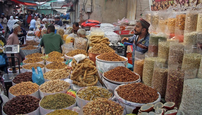 A dry fruit seller stands at his stall at Joona Bazaar in Karachi on November 27, 2023. — Online
