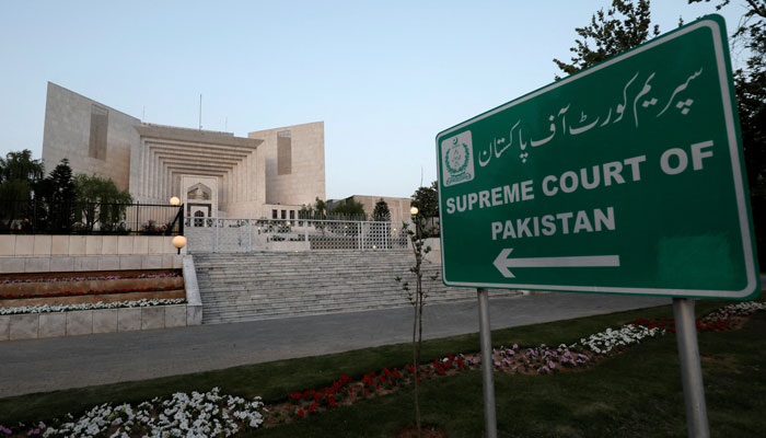 A billboard pointing towards the Supreme Court of Pakistan building. — Reuters/File