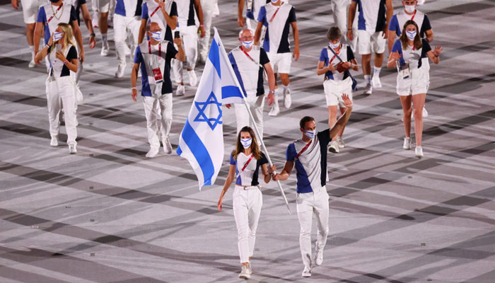HANNA MINENKO and Yaakov Toumarkin lead the Israeli delegation of athletes at the opening of the Tokyo Olympics, in which the country captured four medals.—Reuters/file