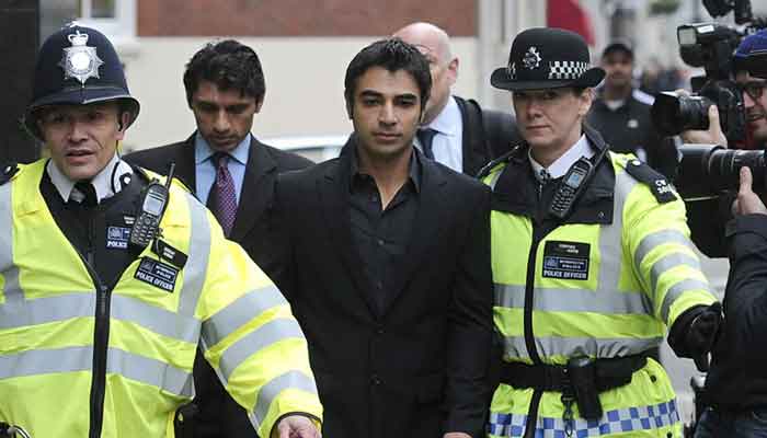 Salman Butt is given a police escort, London, March 17, 2011. —AFP