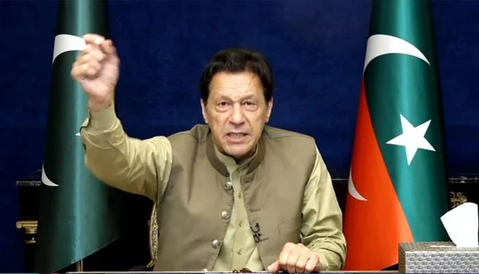 Former PTI chairman Imran Khan addresses party workers and supporters via video link from Lahore on March 19, 2023, in this still taken from a video. — YouTube/PTI