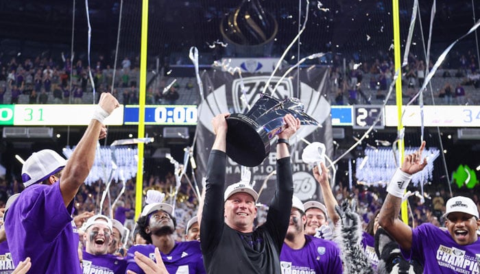 Head coach Kalen DeBoer of the Washington Huskies celebrates with his team while lifting the Pac-12 Championship trophy after his team´s 34-31 win against the Oregon Ducks during the Pac-12 Championship at Allegiant Stadium in Las Vegas, Nevada on December 1, 2023. — AFP