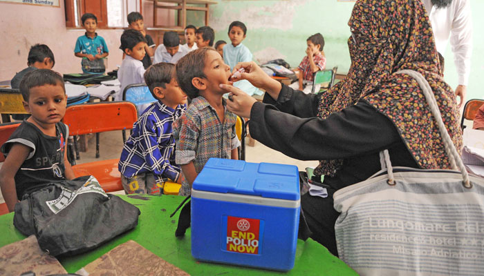 Health workers administer anti-polio vaccine to the children during the polio eradication drive in Hyderabad. — Online/File