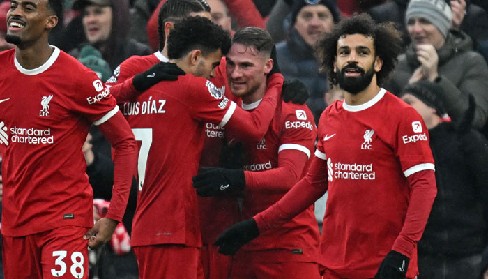 Liverpool´s Argentinian midfielder Alexis Mac Allister (second right) celebrates with teammates after scoring their second goal during the English Premier League football match between Liverpool and Fulham at Anfield in Liverpool, northwest England, on December 3, 2023. — AFP
