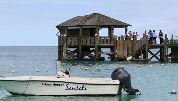People gathered at a pier near the scene of the shark attack in Bahamas.—Reuters