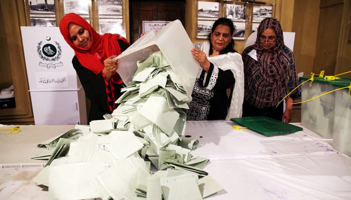 Election officials count ballots after polls closed during the general election in Islamabad, , on July 25, 2018. — Reuters