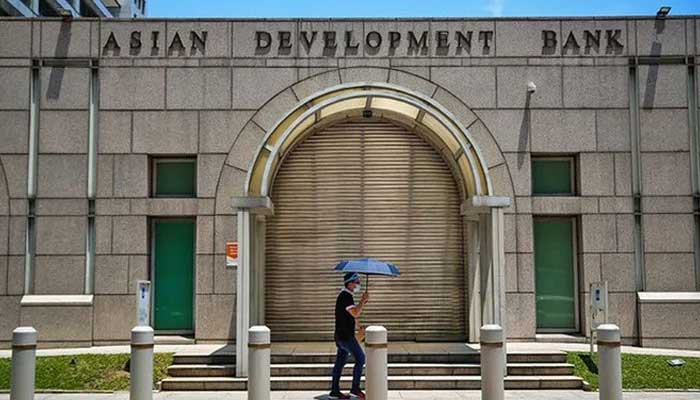 A man walks past the Asian Development Bank (ADB) building in Ortigas City, Philippines on October 8, 2021. — Reuters