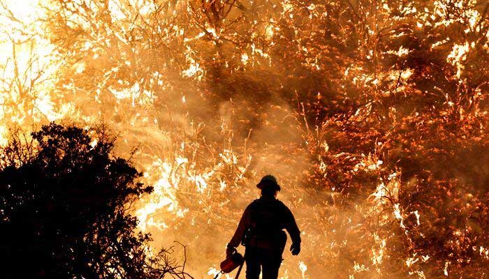 A firefighter works as the Caldor Fire burns in Grizzly Flats, California, US, August 22, 2021. — Reuters