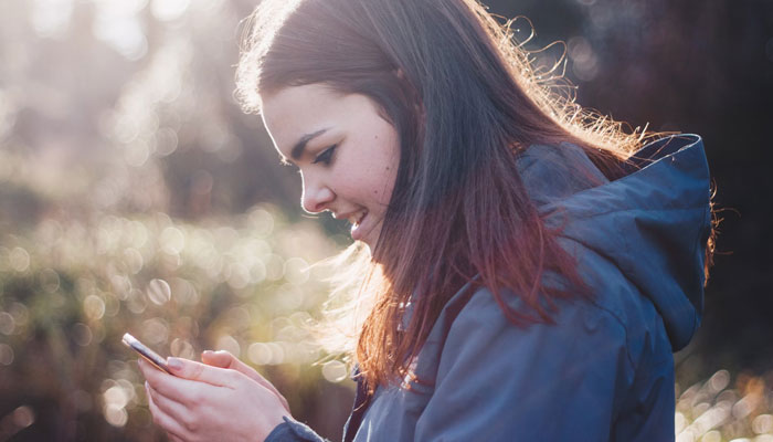 A representational image of a girl using a mobile phone. — Unsplash