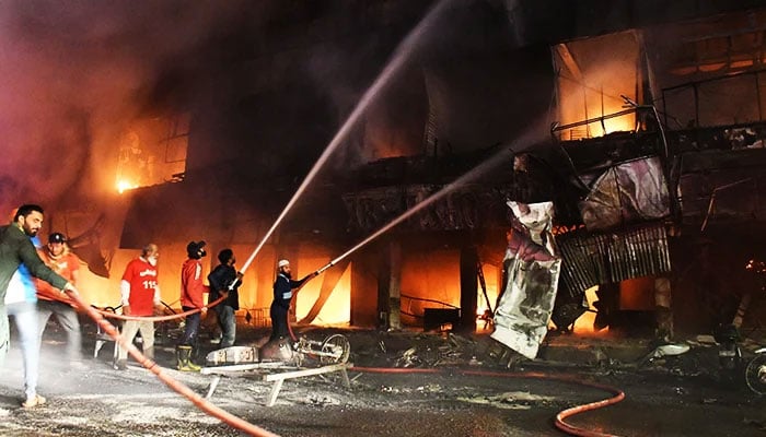 Firefighters try to control blazes that broke out at furniture shops at Ayesha Manzil in Karachi on December 06, 2023. — Online