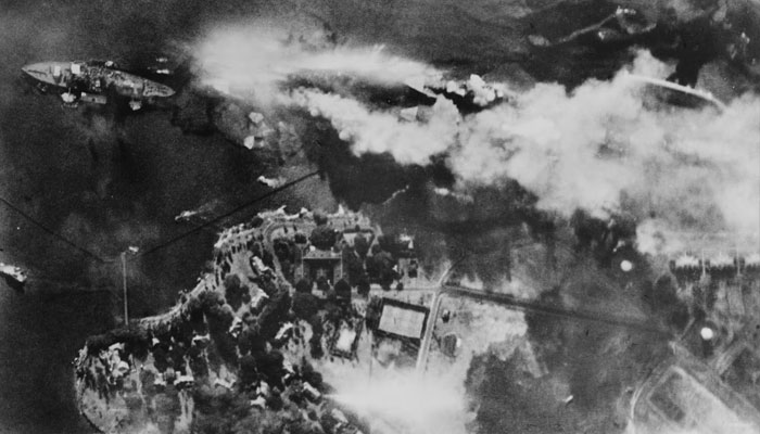 The battleship USS Arizona burns on Battleship Row, beside Ford Island in an aerial photo taken from a Japanese aircraft during the attack.—Reuters
