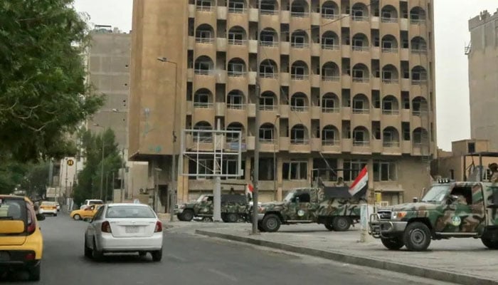 Iraqi security forces stand guard near Baghdads high-security Green Zone neighbourhood, in which the US embassy is located. — AFP/File