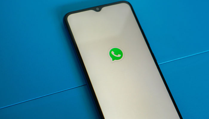 A representational image of a phone with WhatsApp logo. — Unsplash