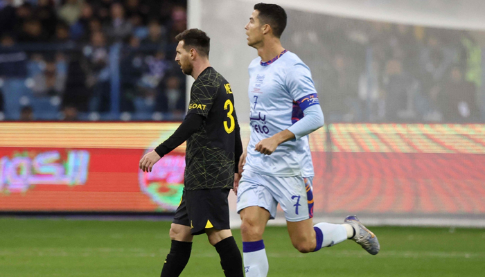 Paris Saint-Germains Argentine forward Lionel Messi (left) and Riyadh All-Stars Portuguese forward Cristiano Ronaldo (right) on the pitch during the Riyadh Season Cup football match at the King Fahd Stadium in Riyadh, Saudi Arabia, Jan. 19, 2023. — AFP