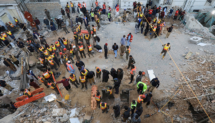 Rescue workers look for survivors under a collapsed roof, after a suicide blast in a mosque in Peshawar, on January 30, 2023. — Reuters