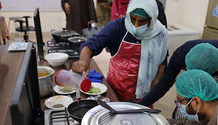 A trans person is seen taking a cooking class at the newly established lab on December 9, 2023. — Reporter