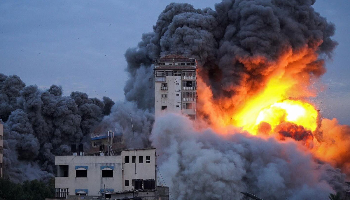 A photograph of an airstrike targeting a building in Gaza from early days of Israeli aggression. — X/@@azaizamotaz9