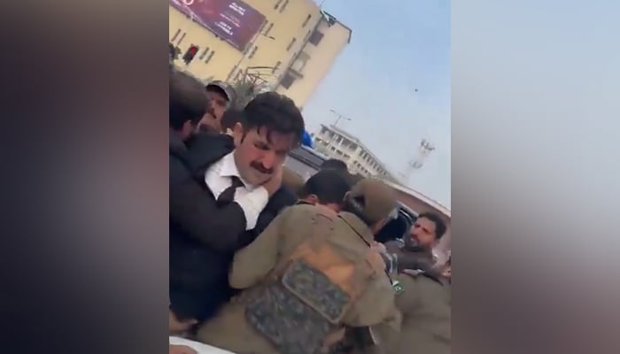 PTI Senior Vice President Sher Afzal Khan Marwat being arrested in Lahore, on December 14, 2023, in this still taken from a video. — X/@AkMashal