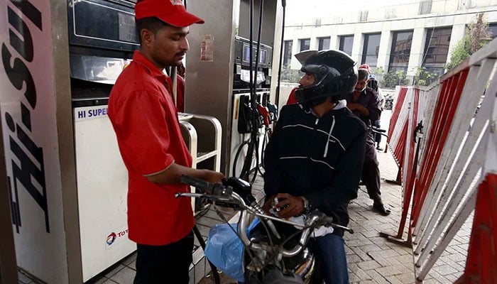 Fuel station worker fills petrol in a motorcycle at a petrol pump in Karachi on September 1, 2023. — PPI