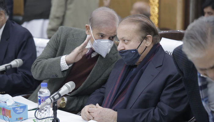 PML-N President Shehbaz Sharif is seated with party supremo Nawaz Sharif in this photograph. — X/@pmln_org