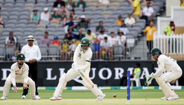 Australia´s Usman Khawaja (C) plays a shot during day three of the first Test cricket match between Australia and Pakistan in Perth on December 16, 2023. —AFP