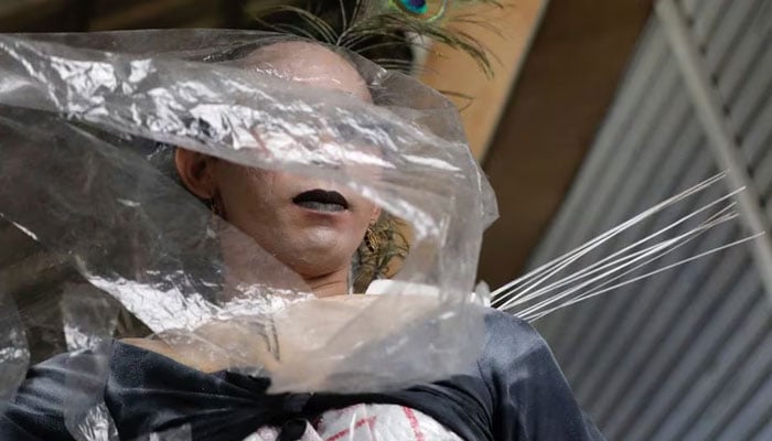 cha, 43, a trans woman presents a recycled material to bring awareness to LGBT rights and environmental protection during a Trans Super Heroes fashion show at a traditional market in Jakarta, Indonesia, December 17, 2023. —Reuters
