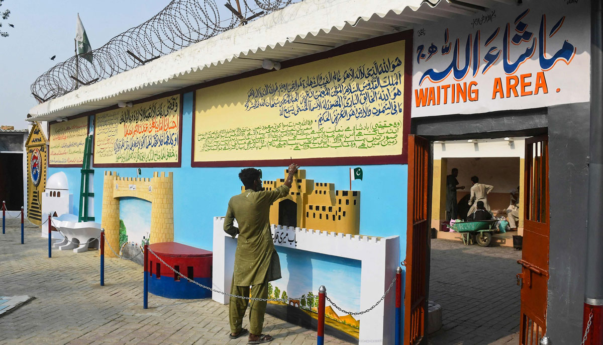 In this photograph taken on December 16, 2023, a prisoner works on a wall mural at the Central Jail in Karachi. — AFP