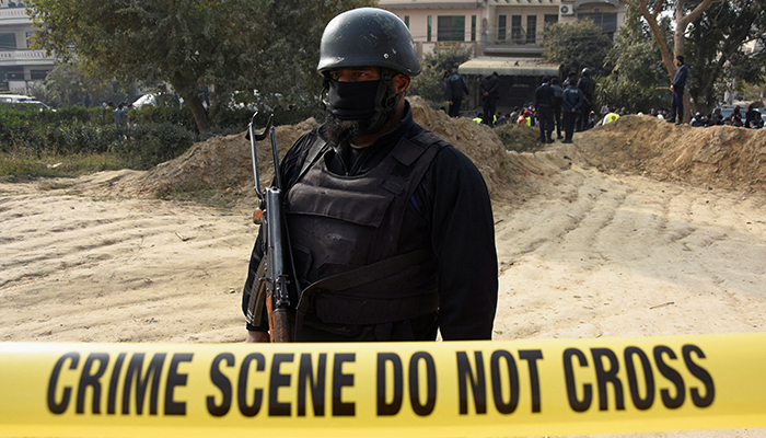 A police officer stands inside cordoned-off area after a suicide car bombing in Islamabad, Pakistan December 23, 2022. — Reuters