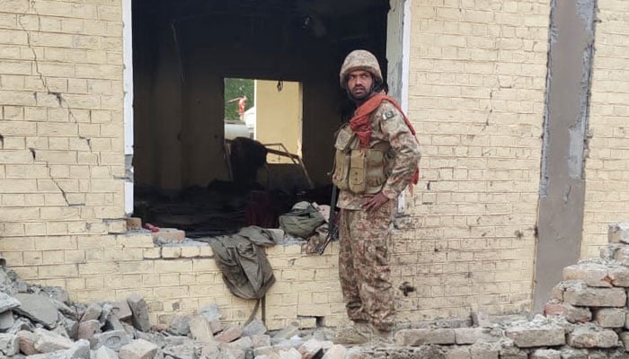 A Pakistani Army soldier stands at the site of Dera Ismail Khan attack. — Geo News