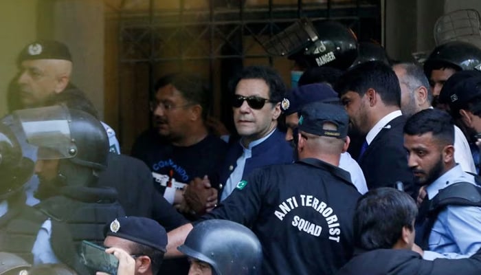 Security officers escort former prime minister Imran Khan, as he appeared in Islamabad High Court, in Islamabad, on May 12, 2023. — Reuters