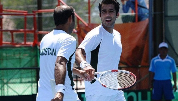 Pakistan tennis player Aisam-ul-Haq Qureshi during a match with a fellow player. — AFP/File